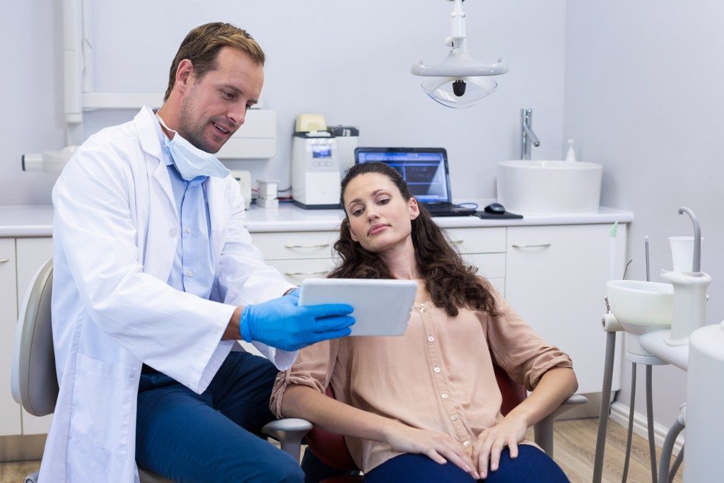 Dentist discussing to a patient