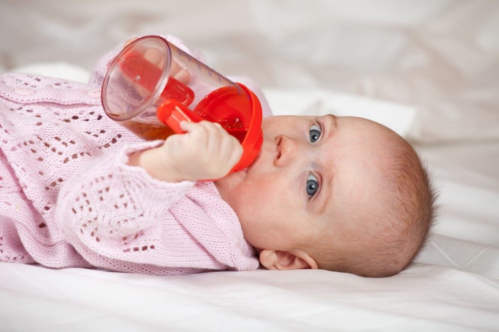 Baby drinking on her cup