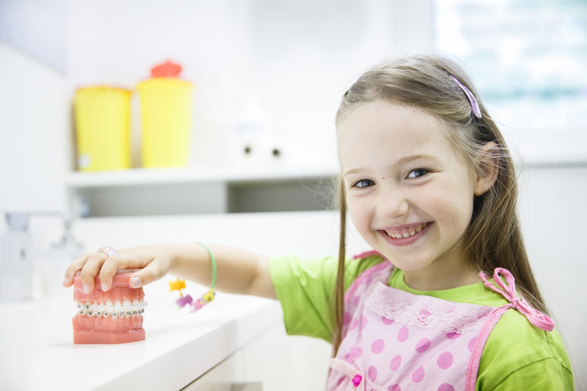 Child holding teeth model