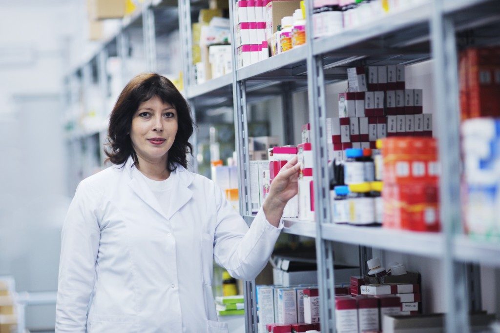 pharmacist with a stock of medication
