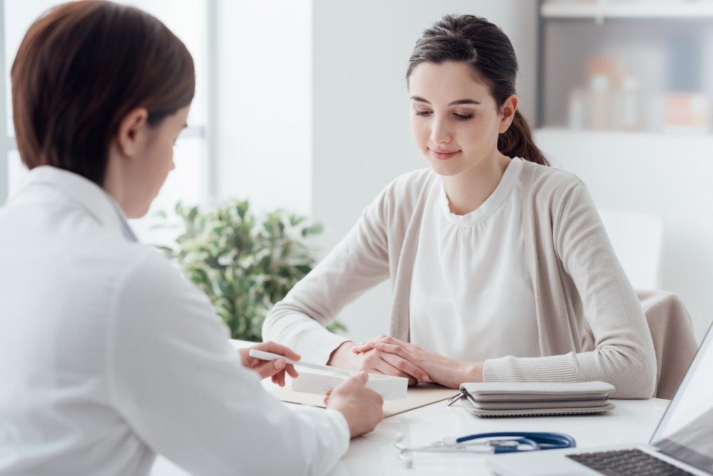 Woman consulting Doctor about haemorrhoids