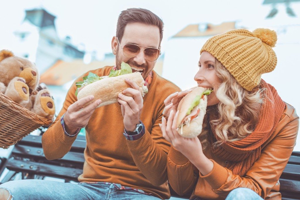 Couple eating sandwhich