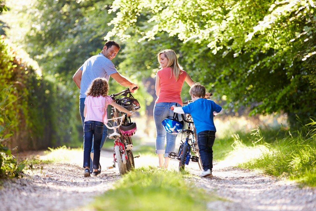 Family walking with their bikes