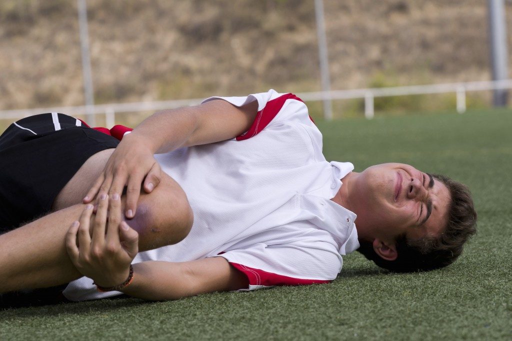 Footballer having a muscle pain