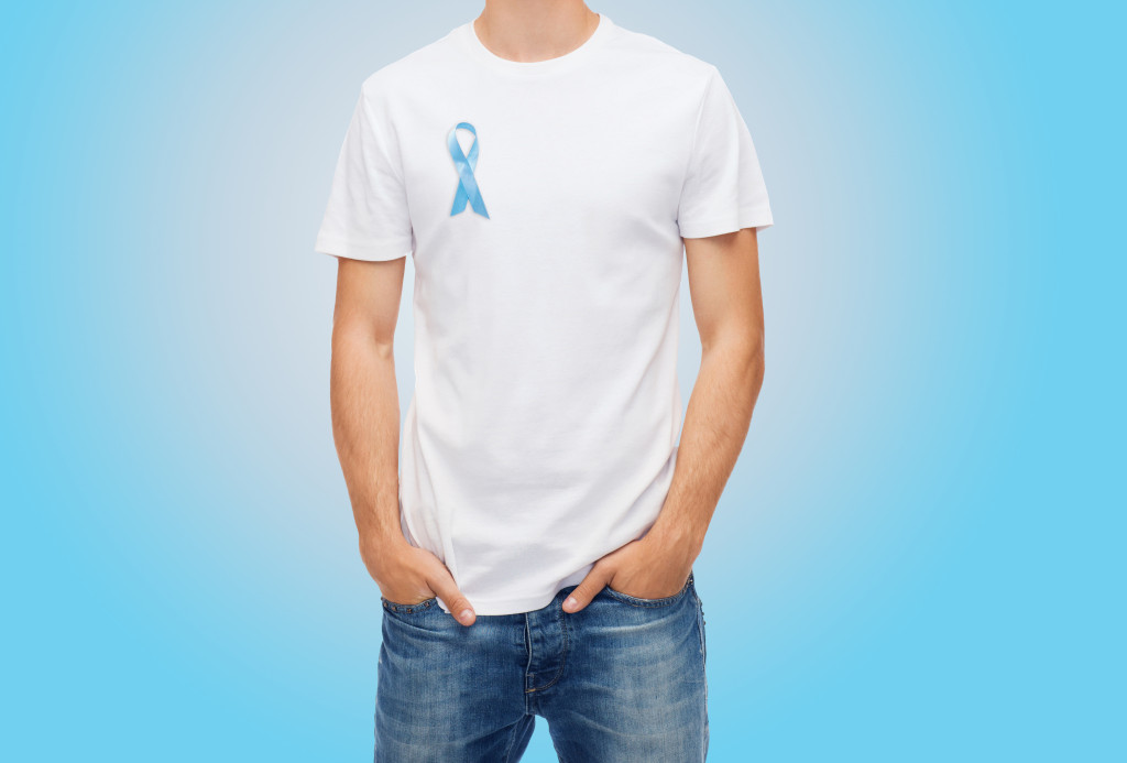 man with blue ribbon for porstate cancer awareness