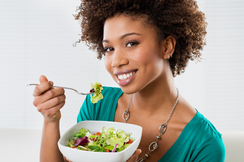 woman with a bowl of vegetable salad