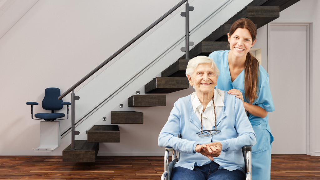 A senior on a wheelchair with her home nurse